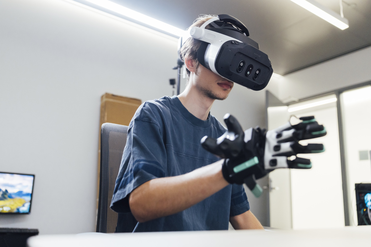 Beckett wearing a VR headset and glove.