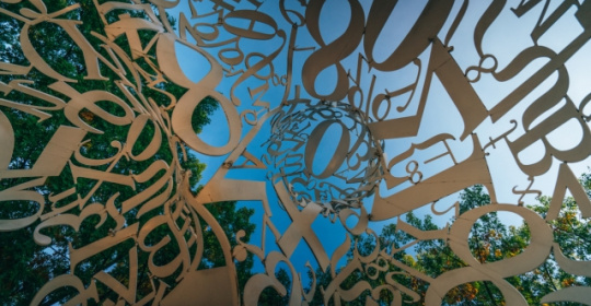 letters and symbols against a blue sky 